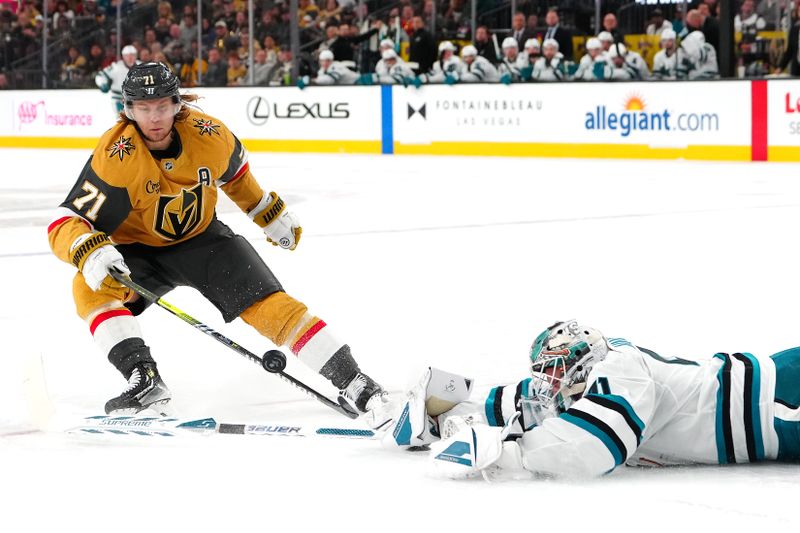 Oct 26, 2024; Las Vegas, Nevada, USA; Vegas Golden Knights center William Karlsson (71) tips the puck over the stick of San Jose Sharks goaltender Vitek Vanecek (41) during the second period at T-Mobile Arena. Mandatory Credit: Stephen R. Sylvanie-Imagn Images