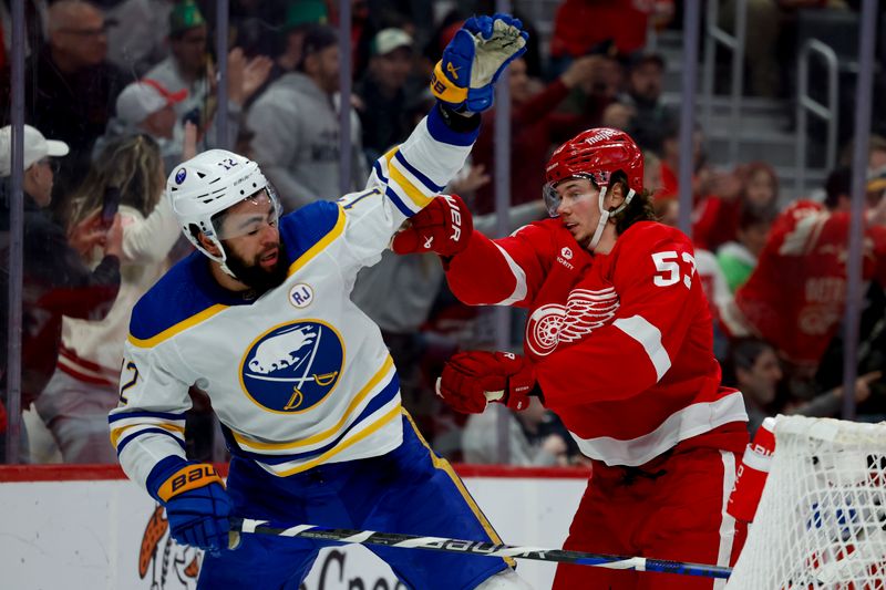 Mar 16, 2024; Detroit, Michigan, USA;  Detroit Red Wings defenseman Moritz Seider (53) shoves Buffalo Sabres left wing Jordan Greenway (12) in the third period at Little Caesars Arena. Mandatory Credit: Rick Osentoski-USA TODAY Sports