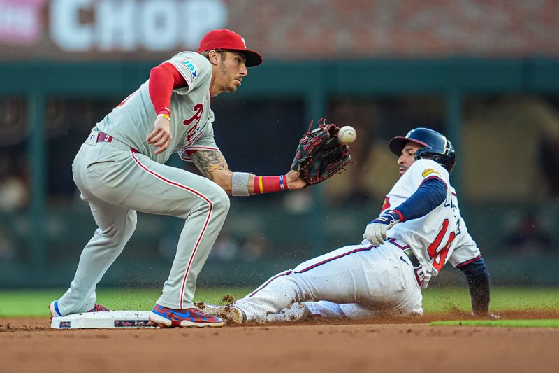 Aug 20, 2024; Cumberland, Georgia, USA; Atlanta Braves right fielder Ramon Laureano (18) steals second base under Philadelphia Phillies second baseman Bryson Stott (5) but the steal is nullified by a catcher interference call during the first inning at Truist Park. Mandatory Credit: Dale Zanine-USA TODAY Sports