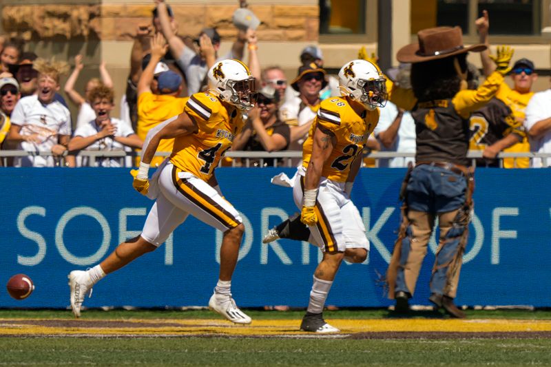 Sep 3, 2022; Laramie, Wyoming, USA; Wyoming Cowboys linebacker Easton Gibbs (28) scores a touchdown against against the Tulsa Golden Hurricane during the first quarter at Jonah Field at War Memorial Stadium. Mandatory Credit: Troy Babbitt-USA TODAY Sports