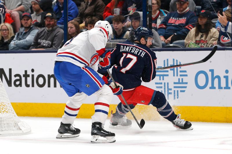 Nov 27, 2024; Columbus, Ohio, USA; Montreal Canadiens left wing Emil Heineman (51) and Columbus Blue Jackets right wing Justin Danforth (17) chase after a loose puck during the second period at Nationwide Arena. Mandatory Credit: Russell LaBounty-Imagn Images