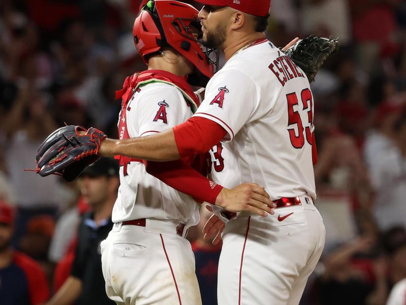 Sep 9, 2023; Anaheim, California, USA;  Los Angeles Angels relief pitcher Carlos Estevez (53) celebrates a victory with catcher Logan O'Hoppe (14) after defeating the Cleveland Guardians 6-2 at Angel Stadium. Mandatory Credit: Kiyoshi Mio-USA TODAY Sports