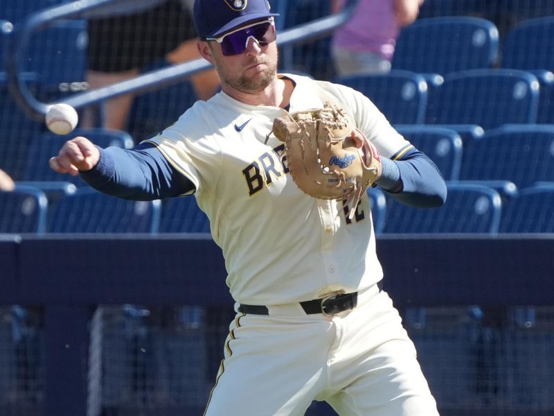 Feb 26, 2025; Phoenix, Arizona, USA; Milwaukee Brewers first base Rhys Hoskins (12) makes the play for an out against the Los Angeles Dodgers during the third inning at American Family Fields of Phoenix. Mandatory Credit: Rick Scuteri-Imagn Images