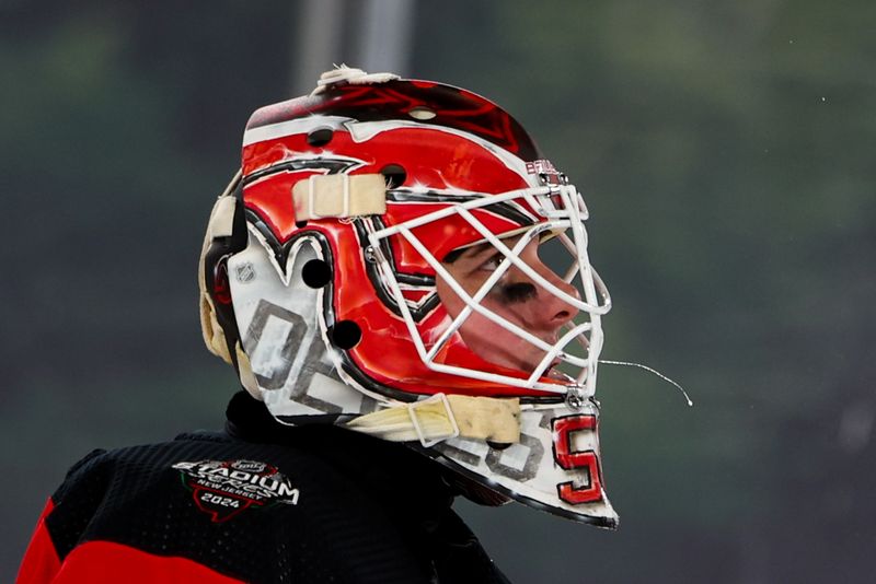 Feb 17, 2024; East Rutherford, New Jersey, USA; New Jersey Devils goaltender Nico Daws (50) against the Philadelphia Flyers during the third period in a Stadium Series ice hockey game at MetLife Stadium. Mandatory Credit: Ed Mulholland-USA TODAY Sports