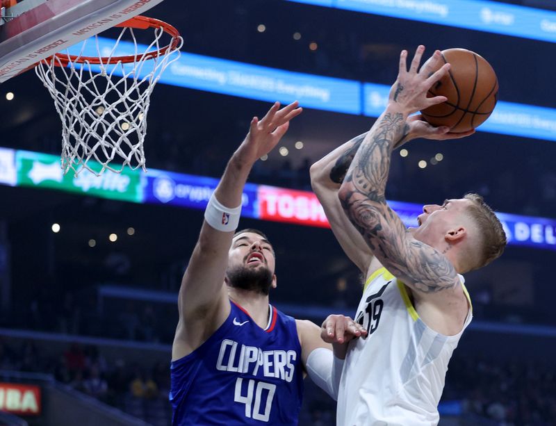 LOS ANGELES, CALIFORNIA - APRIL 12: Luka Samanic #19 of the Utah Jazz shoots in front of Ivica Zubac #40 of the LA Clippers during a 110-109 Jazz win at Crypto.com Arena on April 12, 2024 in Los Angeles, California. User is consenting to the terms and conditions of the Getty Images License Agreement.  (Photo by Harry How/Getty Images)