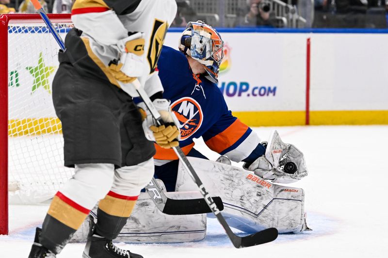 Jan 23, 2024; Elmont, New York, USA;  New York Islanders goaltender Ilya Sorokin (30) makes a glove save against the Vegas Golden Knights during the third period at UBS Arena. Mandatory Credit: Dennis Schneidler-USA TODAY Sports