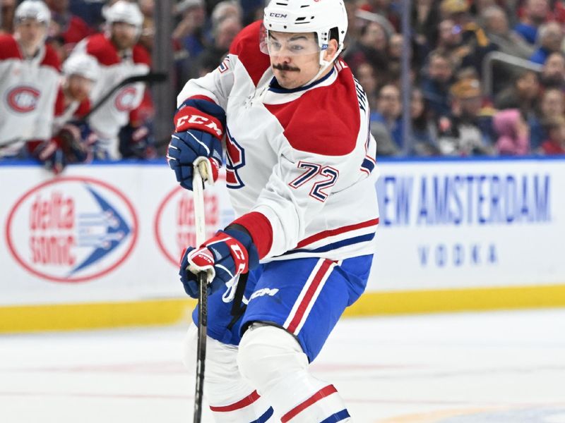 Nov 11, 2024; Buffalo, New York, USA; Montreal Canadiens defenseman Arber Xhekaj (72) takes a shot against the Buffalo Sabres in the first period at KeyBank Center. Mandatory Credit: Mark Konezny-Imagn Images