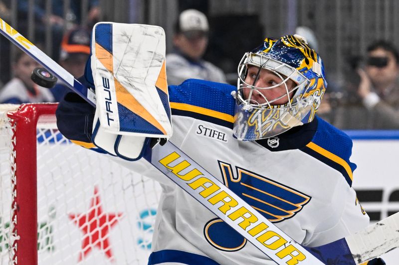 Mar 5, 2024; Elmont, New York, USA;  St. Louis Blues goaltender Joel Hofer (30) attempts a save against the New York Islanders during the second period at UBS Arena. Mandatory Credit: Dennis Schneidler-USA TODAY Sports