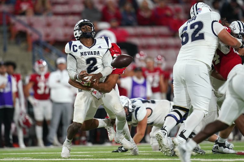 Sep 30, 2023; Fresno, California, USA; Nevada Wolf Pack quarterback Brendon Lewis (2) fumbles the ball after being hit by Fresno State Bulldogs defensive lineman Jacob Holmes (23) in the fourth quarter at Valley Children's Stadium. Mandatory Credit: Cary Edmondson-USA TODAY Sports