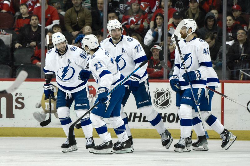 Feb 25, 2024; Newark, New Jersey, USA; Tampa Bay Lightning center Brayden Point (21) celebrates with teammates after scoring a goal against the New Jersey Devils during the second period at Prudential Center. Mandatory Credit: John Jones-USA TODAY Sports