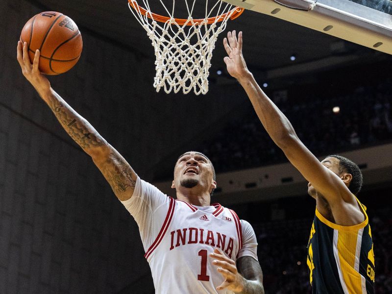 Feb 28, 2023; Bloomington, Indiana, USA; Indiana Hoosiers guard Jalen Hood-Schifino (1) shoots the ball while Iowa Hawkeyes forward Kris Murray (24) defends in the first half at Simon Skjodt Assembly Hall. Mandatory Credit: Trevor Ruszkowski-USA TODAY Sports