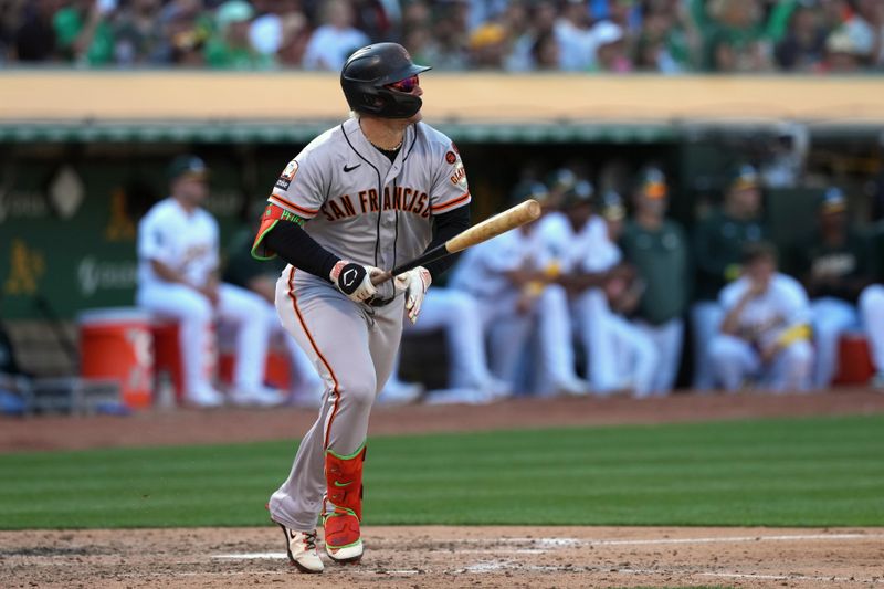 Aug 5, 2023; Oakland, California, USA; San Francisco Giants left fielder Joc Pederson (23) hits an RBI sacrifice fly against the Oakland Athletics during the eighth inning at Oakland-Alameda County Coliseum. Mandatory Credit: Darren Yamashita-USA TODAY Sports