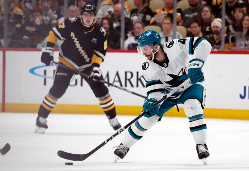 Mar 14, 2024; Pittsburgh, Pennsylvania, USA; San Jose Sharks defenseman Kyle Burroughs (4) moves the puck against  the Pittsburgh Penguins during the third period at PPG Paints Arena. Pittsburgh won 6-3. Mandatory Credit: Charles LeClaire-USA TODAY Sports