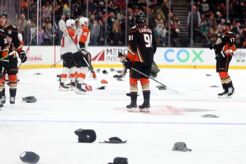 Nov 10, 2023; Anaheim, California, USA; Fans throw hats as Anaheim Ducks center Leo Carlsson (91) records a hat trick during the third period against the Philadelphia Flyers at Honda Center. Mandatory Credit: Kiyoshi Mio-USA TODAY Sports