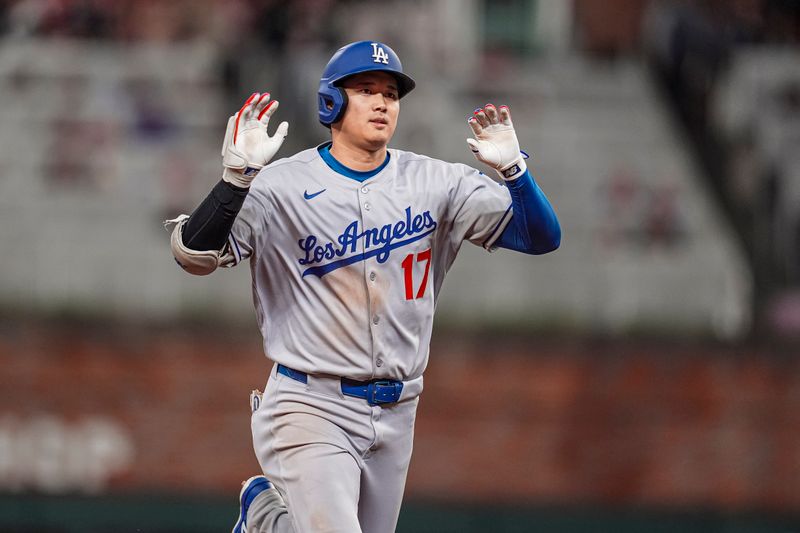 May 3, 2025; Cumberland, Georgia, USA; Los Angeles Dodgers designated hitter Shohei Ohtani (17) reacts after hitting a home run against the Atlanta Braves during the third inning at Truist Park. Mandatory Credit: Dale Zanine-Imagn Images