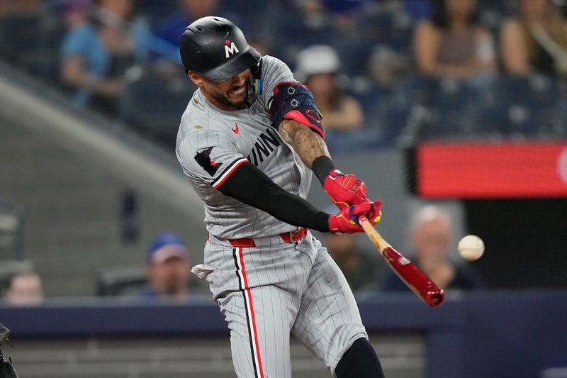 May 10, 2024; Toronto, Ontario, CAN; Minnesota Twins shortstop Carlos Correa (4) hits a single against the Toronto Blue Jays during the first inning at Rogers Centre. Mandatory Credit: John E. Sokolowski-USA TODAY Sports