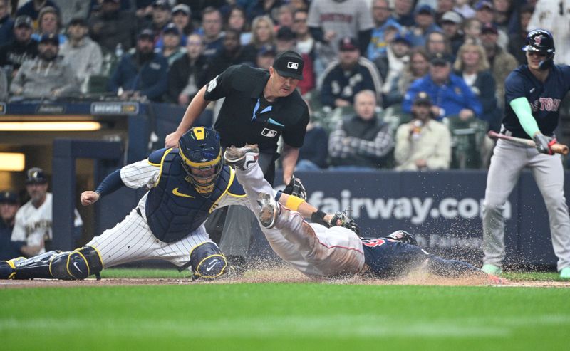 Apr 23, 2023; Milwaukee, Wisconsin, USA; Boston Red Sox right fielder Alex Verdugo (99) slide safely into home plate ahead of the tag from Milwaukee Brewers catcher Victor Caratini (7) at American Family Field. Mandatory Credit: Michael McLoone-USA TODAY Sports