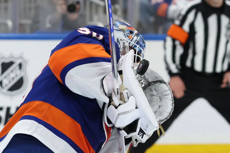 Jan 18, 2025; Elmont, New York, USA;  New York Islanders goaltender Marcus Hogberg (50) makes a stop against the San Jose Sharks during the third period at UBS Arena. Mandatory Credit: Thomas Salus-Imagn Images