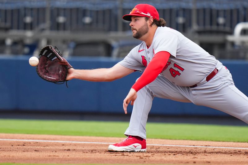 Mar 4, 2025; West Palm Beach, Florida, USA; St. Louis Cardinals outfielder Alec Burleson (41) catches the ball at first base for an out against the Washington Nationals during the first inning at CACTI Park of the Palm Beaches. Mandatory Credit: Rich Storry-Imagn Images