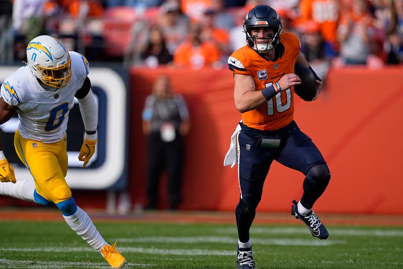 Denver Broncos quarterback Bo Nix (10) runs with the football as Los Angeles Chargers linebacker Daiyan Henley (0) follows during the second half of an NFL football game, Sunday, Oct. 13, 2024, in Denver. (AP Photo/David Zalubowski)