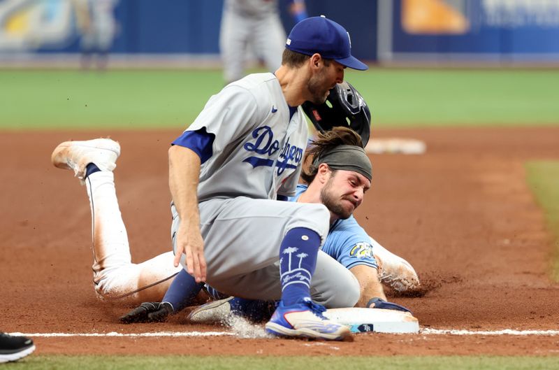 May 28, 2023; St. Petersburg, Florida, USA; Tampa Bay Rays right fielder Josh Lowe (15) steals third base as Los Angeles Dodgers infielder Chris Taylor (3) attempted to tag him out during the fourth inning at Tropicana Field. Mandatory Credit: Kim Klement-USA TODAY Sports