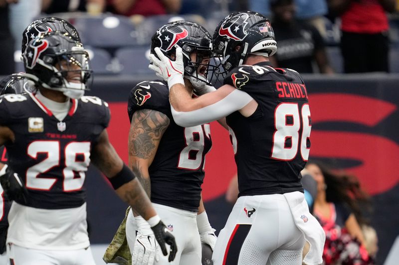 Houston Texans tight end Cade Stover, center, celebrates his touchdown with teammate Dalton Schultz (86) during the first half of an NFL football game against the Tennessee Titans, Sunday, Nov. 24, 2024, in Houston. (AP Photo/Ashley Landis)