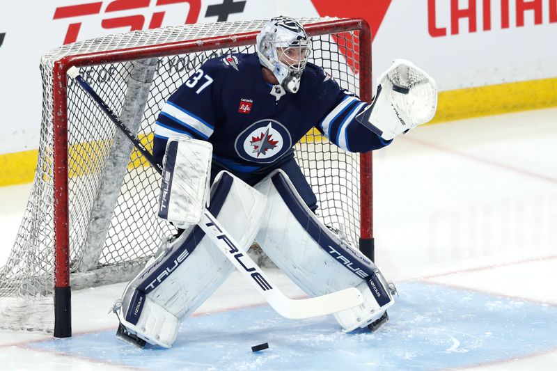 Apr 4, 2024; Winnipeg, Manitoba, CAN; Winnipeg Jets goaltender Connor Hellebuyck (37) warms up before a game against the Calgary Flames at Canada Life Centre. Mandatory Credit: James Carey Lauder-USA TODAY Sports