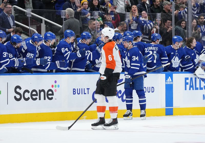 Feb 15, 2024; Toronto, Ontario, CAN; Toronto Maple Leafs center Auston Matthews (34) celebrates with teammates after scoring his second goal against the Philadelphia Flyers during the second period at Scotiabank Arena. Mandatory Credit: Nick Turchiaro-USA TODAY Sports