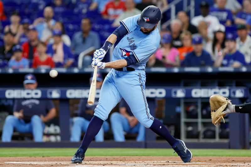 Jun 21, 2023; Miami, Florida, USA; Toronto Blue Jays designated hitter Brandon Belt (13) hits a single against the Miami Marlins during the first inning at loanDepot Park. Mandatory Credit: Sam Navarro-USA TODAY Sports