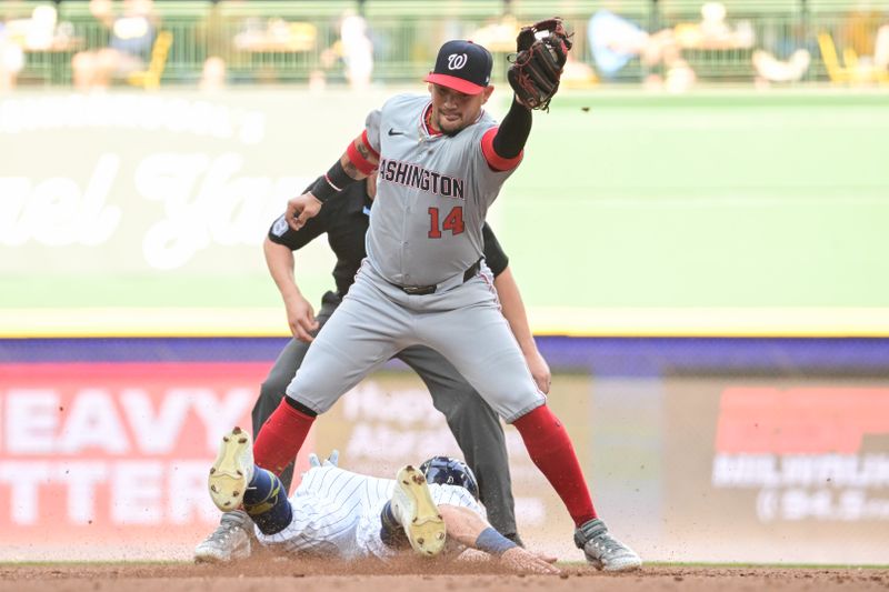 Jul 13, 2024; Milwaukee, Wisconsin, USA; Milwaukee Brewers right fielder Sal Frelick (10) steals second base before tag by Washington Nationals second baseman Ildemaro Vargas (14) in the third inning at American Family Field. Mandatory Credit: Benny Sieu-USA TODAY Sports