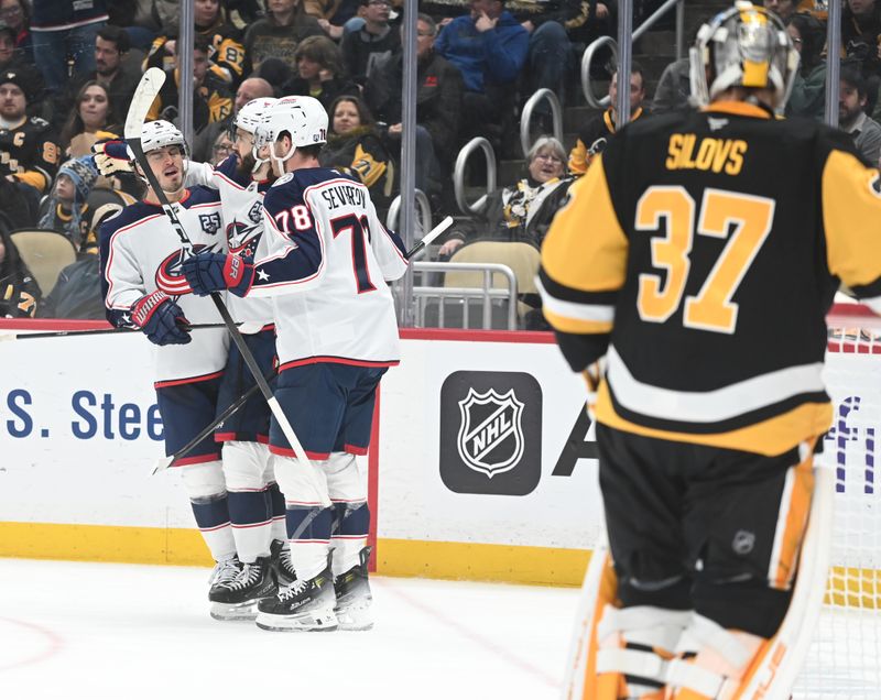 Jan 17, 2026; Pittsburgh, Pennsylvania, USA;  Columbus Blue Jackets right wing Kirill Marchenko (86) celebrates a goal with center Cole Sillinger (4) and defenseman Damon Severson (78) after scoring on Pittsburgh Penguins goalie Arturs Silovs (37) during the second period at PPG Paints Arena. Mandatory Credit: Philip G. Pavely-Imagn Images