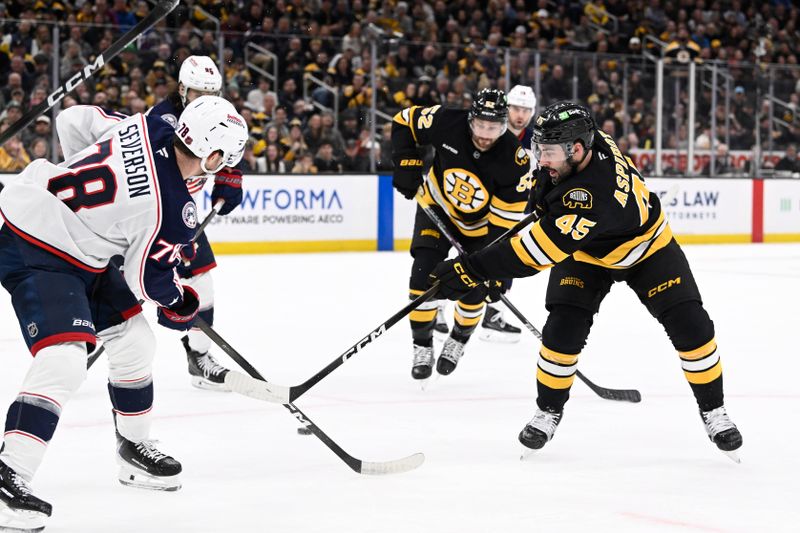 Feb 26, 2026; Boston, Massachusetts, USA; Boston Bruins defenseman Jonathan Aspirot (45) shoots against Columbus Blue Jackets defenseman Damon Severson (78) during the first period at TD Garden. Mandatory Credit: Eric Canha-Imagn Images