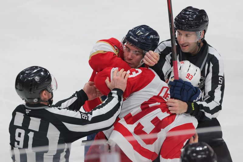 Jan 16, 2025; Sunrise, Florida, USA; Florida Panthers center Evan Rodrigues (17) and Detroit Red Wings center Marco Kasper (92) scuffle during the second period at Amerant Bank Arena. Mandatory Credit: Sam Navarro-Imagn Images