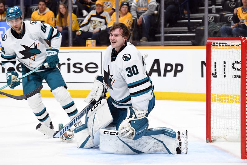 Mar 19, 2024; Nashville, Tennessee, USA; San Jose Sharks goaltender Magnus Chrona (30) loses his helmet on a play during the first period against the Nashville Predators at Bridgestone Arena. Mandatory Credit: Christopher Hanewinckel-USA TODAY Sports