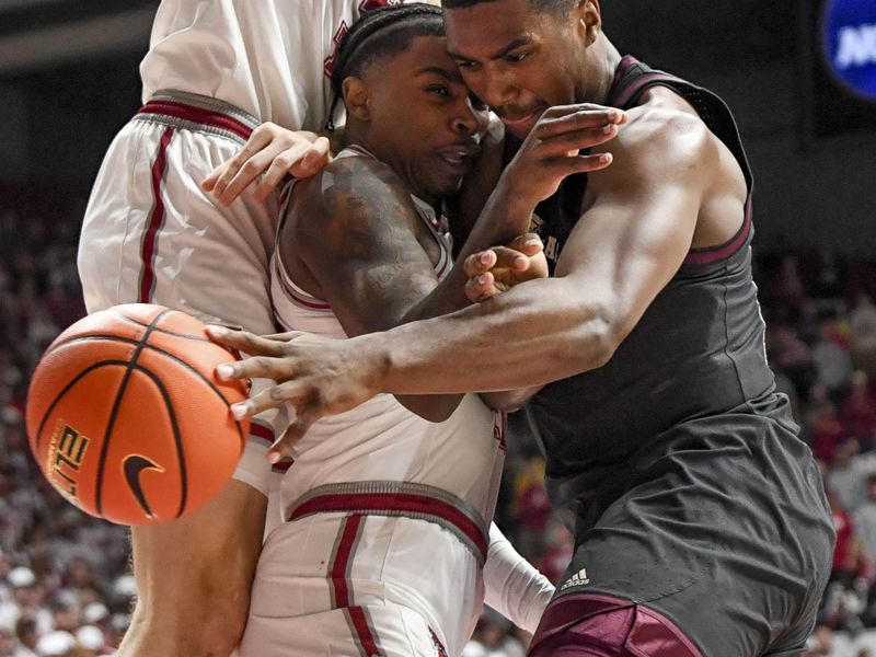 Feb 17, 2024; Tuscaloosa, Alabama, USA;  Alabama Crimson Tide guard Latrell Wrightsell Jr. (middle) is sandwiched between  forward Grant Nelson (2) and Texas A&M Aggies forward Henry Coleman III (15) during the first half at Coleman Coliseum. Mandatory Credit: Gary Cosby Jr.-USA TODAY Sports