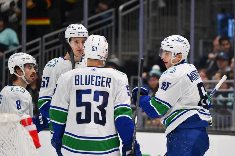 Nov 24, 2023; Seattle, Washington, USA; The Vancouver Canucks celebrate after right wing Ilya Mikheyev (65) scored a goal against the Seattle Kraken during the third period at Climate Pledge Arena. Mandatory Credit: Steven Bisig-USA TODAY Sports