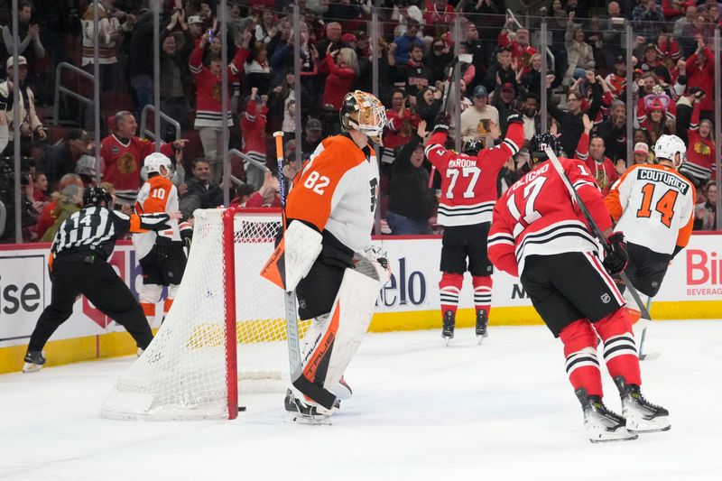Mar 23, 2025; Chicago, Illinois, USA; Philadelphia Flyers goaltender Ivan Fedotov (82) looks on as Chicago Blackhawks left wing Patrick Maroon (77) celebrates after scoring a goal during the first period at United Center. Mandatory Credit: David Banks-Imagn Images