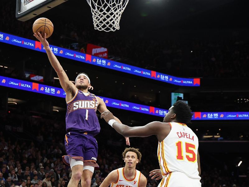 PHOENIX, ARIZONA - JANUARY 09: Devin Booker #1 of the Phoenix Suns lays up a shot past Dyson Daniels #5 of the Atlanta Hawks during the first half of the NBA game at Footprint Center on January 09, 2025 in Phoenix, Arizona. NOTE TO USER: User expressly acknowledges and agrees that, by downloading and or using this photograph, User is consenting to the terms and conditions of the Getty Images License Agreement.  (Photo by Christian Petersen/Getty Images)