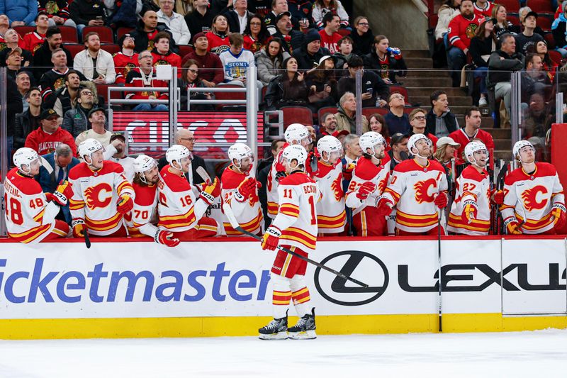 Jan 15, 2026; Chicago, Illinois, USA; Calgary Flames center Mikael Backlund (11) celebrates with teammates after scoring against the Chicago Blackhawks during the first period at United Center. Mandatory Credit: Kamil Krzaczynski-Imagn Images