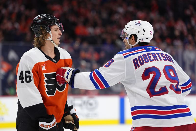 Jan 17, 2026; Philadelphia, Pennsylvania, USA; New York Rangers defenseman Matthew Robertson (29) hits Philadelphia Flyers center Trevor Zegras (46) in the third period at Xfinity Mobile Arena. Mandatory Credit: Kyle Ross-Imagn Images