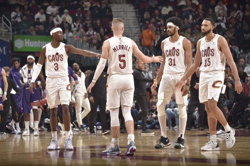 CLEVELAND, OH - MARCH 11:  Caris LeVert #3, Sam Merrill #5, Jarrett Allen #31 high fives Isaiah Mobley #15 of the Cleveland Cavaliers during the game against the Phoenix Suns on March 11, 2024 at Rocket Mortgage FieldHouse in Cleveland, Ohio. NOTE TO USER: User expressly acknowledges and agrees that, by downloading and/or using this Photograph, user is consenting to the terms and conditions of the Getty Images License Agreement. Mandatory Copyright Notice: Copyright 2024 NBAE (Photo by David Liam Kyle/NBAE via Getty Images)