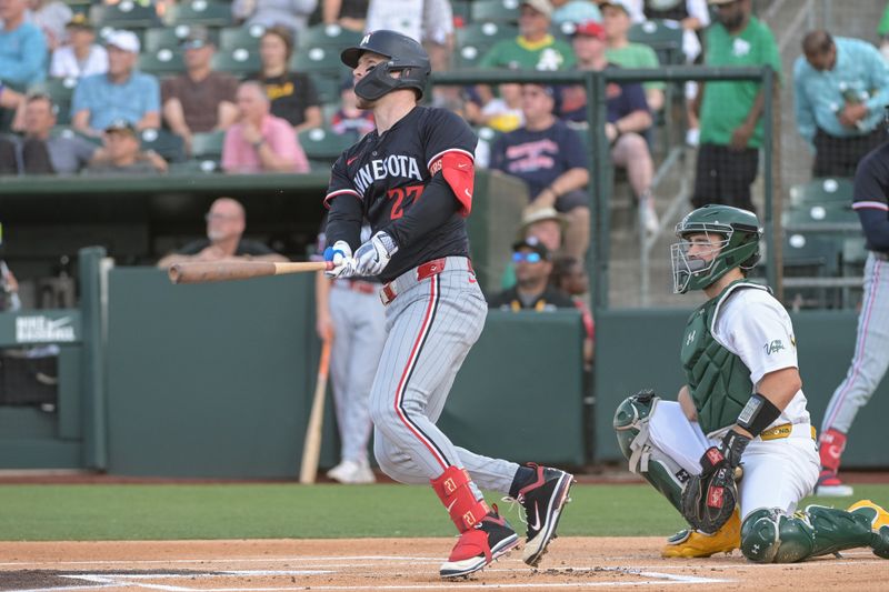 Jun 4, 2025; West Sacramento, California, USA; Minnesota Twins catcher Ryan Jeffers (27) hits a home run against the Athletics during the first inning at Sutter Health Park. Mandatory Credit: Ed Szczepanski-Imagn Images