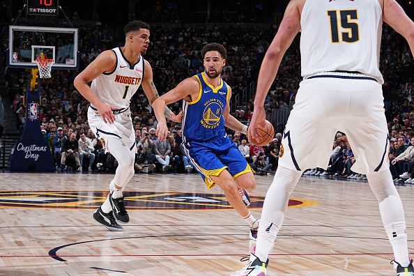 DENVER, CO - DECEMBER 25: Klay Thompson #11 of the Golden State Warriors dribbles the ball during the game against the Denver Nuggets on December 25, 2023 at the Ball Arena in Denver, Colorado. NOTE TO USER: User expressly acknowledges and agrees that, by downloading and/or using this Photograph, user is consenting to the terms and conditions of the Getty Images License Agreement. Mandatory Copyright Notice: Copyright 2023 NBAE (Photo by Garrett Ellwood/NBAE via Getty Images)