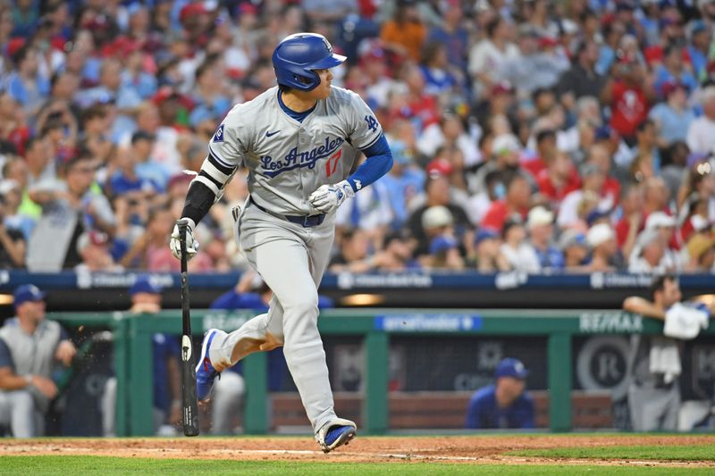 Jul 10, 2024; Philadelphia, Pennsylvania, USA;  Los Angeles Dodgers two-way player Shohei Ohtani (17) hits an RBI single during the fifth inning against the Philadelphia Phillies  at Citizens Bank Park. Mandatory Credit: Eric Hartline-USA TODAY Sports