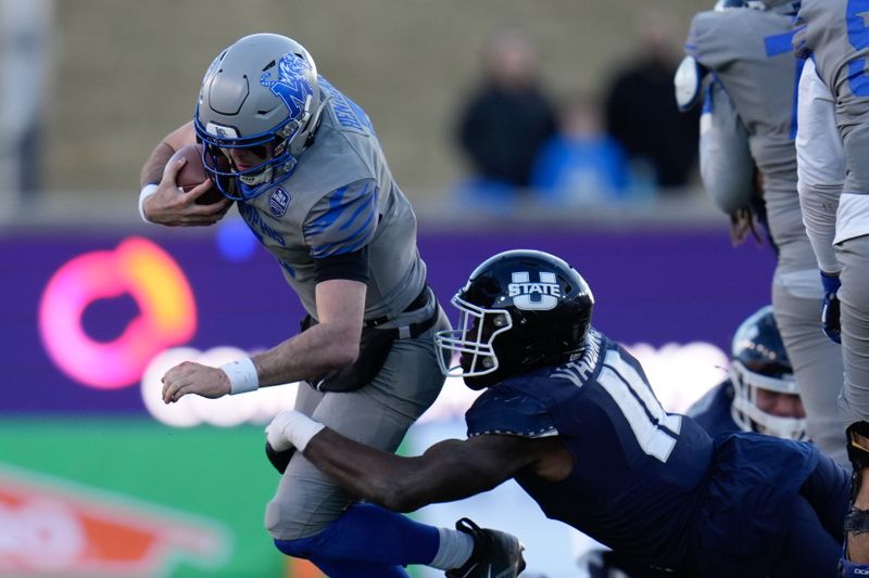 Dec 27, 2022; Dallas, Texas, USA; Utah State Aggies defensive end Byron Vaughns (11) sacks Memphis Tigers quarterback Seth Henigan (5) during the second half in the 2022 First Responder Bowl at Gerald J. Ford Stadium. Mandatory Credit: Chris Jones-USA TODAY Sports