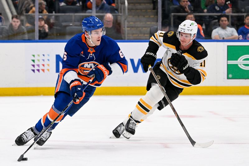 Nov 27, 2024; Elmont, New York, USA;  New York Islanders defenseman Ryan Pulock (6) skates with the puck chased by Boston Bruins center Trent Frederic (11) during the third period at UBS Arena. Mandatory Credit: Dennis Schneidler-Imagn Images