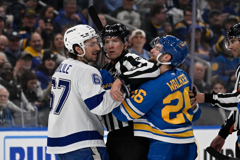 Jan 16, 2026; St. Louis, Missouri, USA; Tampa Bay Lightning defenseman Declan Carlile (67) and St. Louis Blues left wing Nathan Walker (26) get physical during the first period at Enterprise Center. Mandatory Credit: Jeff Le-Imagn Images