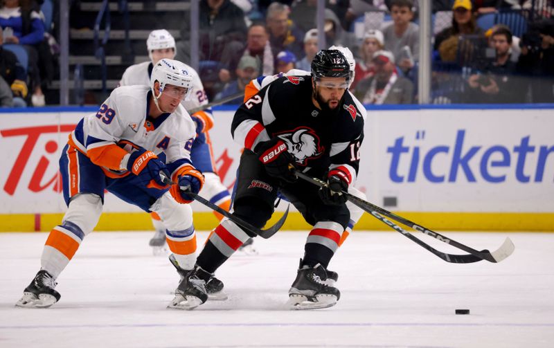 Nov 1, 2024; Buffalo, New York, USA;  New York Islanders center Brock Nelson (29) and Buffalo Sabres left wing Jordan Greenway (12) go after a loose puck during the first period at KeyBank Center. Mandatory Credit: Timothy T. Ludwig-Imagn Images