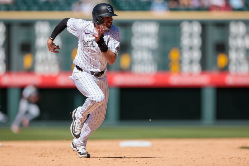 Jun 5, 2024; Denver, Colorado, USA; Colorado Rockies outfielder Jake Cave (11) runs to third during the eighth inning against the Cincinnati Reds at Coors Field. Mandatory Credit: Andrew Wevers-USA TODAY Sports