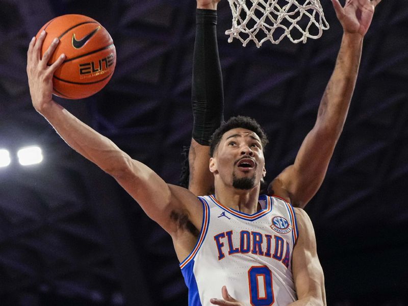 Feb 28, 2023; Athens, Georgia, USA; Florida Gators guard Myreon Jones (0) takes the ball to the basket against the Georgia Bulldogs during the first half at Stegeman Coliseum. Mandatory Credit: Dale Zanine-USA TODAY Sports